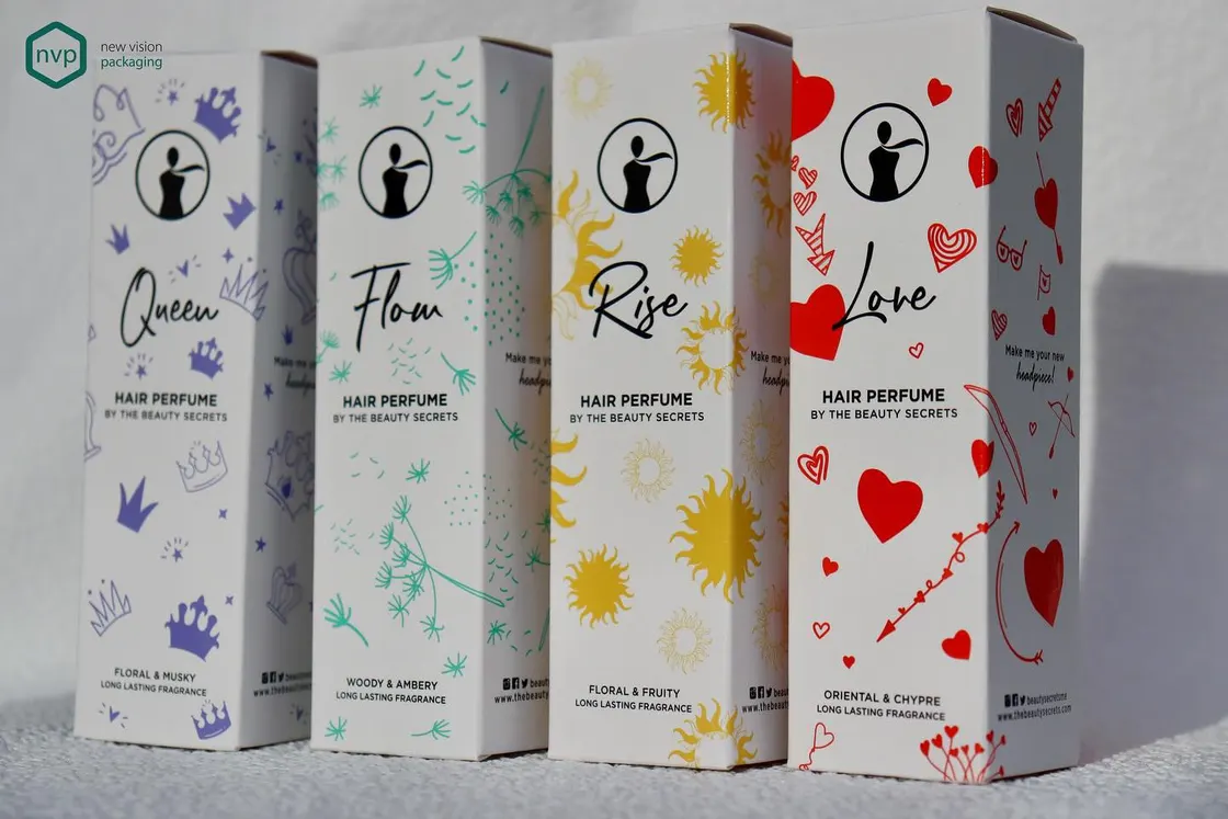 Four Beauty Secrets hair perfume cartons, each printed with its own illustrated pattern for Queen, Flow, Rise and Love