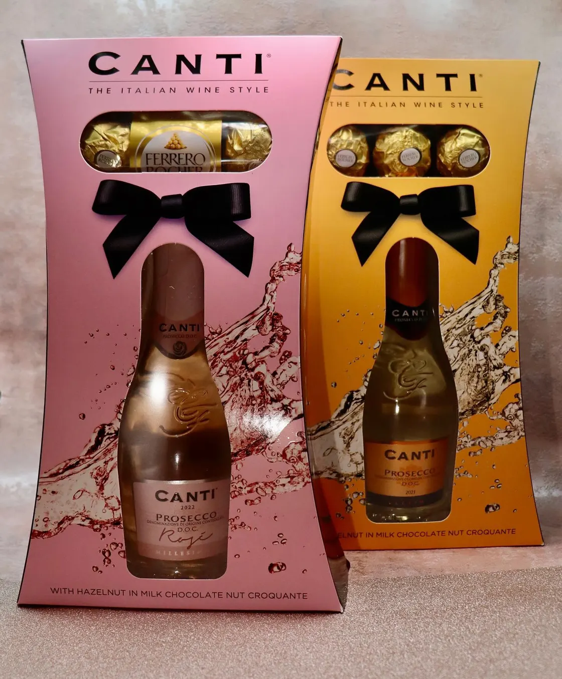 Pink and gold Canti prosecco cartons with embossed ribbon bows and shaped bottle windows