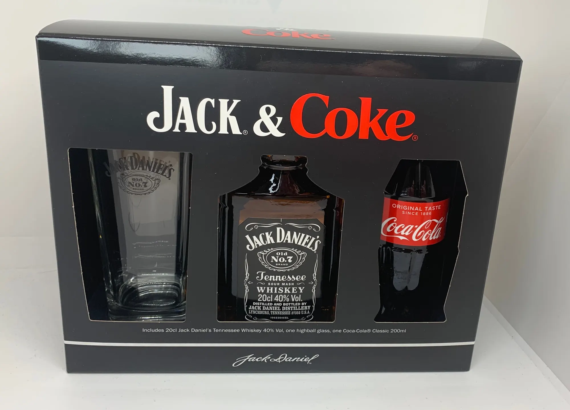 Black Jack Daniel’s and Coca-Cola gift carton holding a whiskey miniature, a can and a branded glass