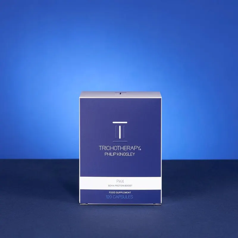 Navy Philip Kingsley Trichotherapy carton photographed against a graduated blue ground