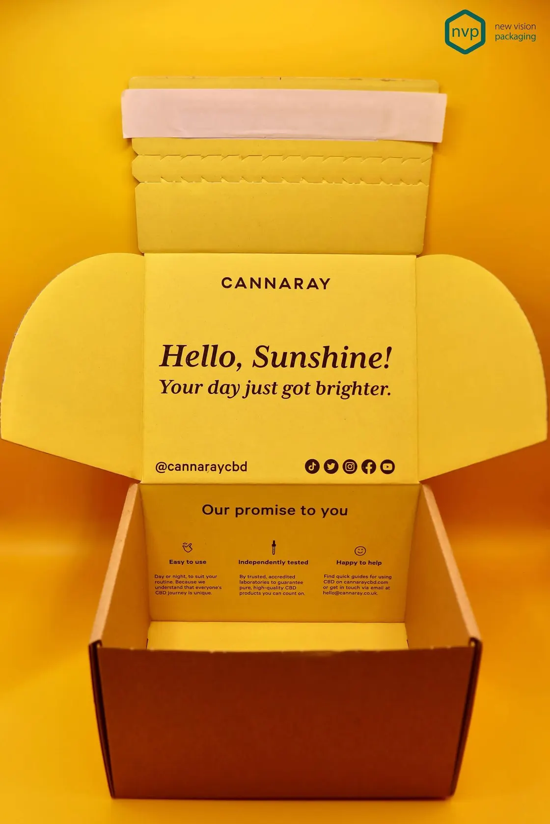 Yellow Cannaray corrugated mailer opened to show a printed message inside the lid