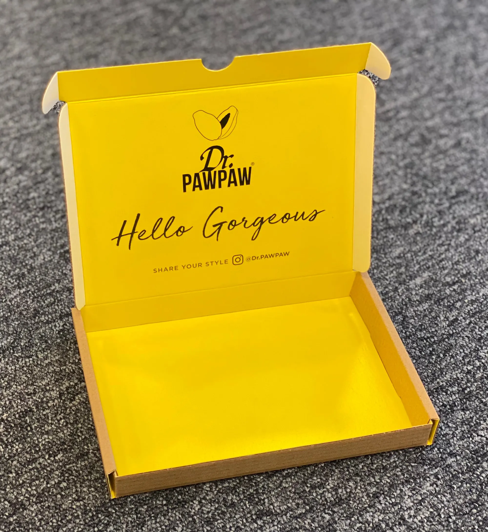 Dr PawPaw corrugated letterbox mailer printed inside in yellow with the line Hello Gorgeous