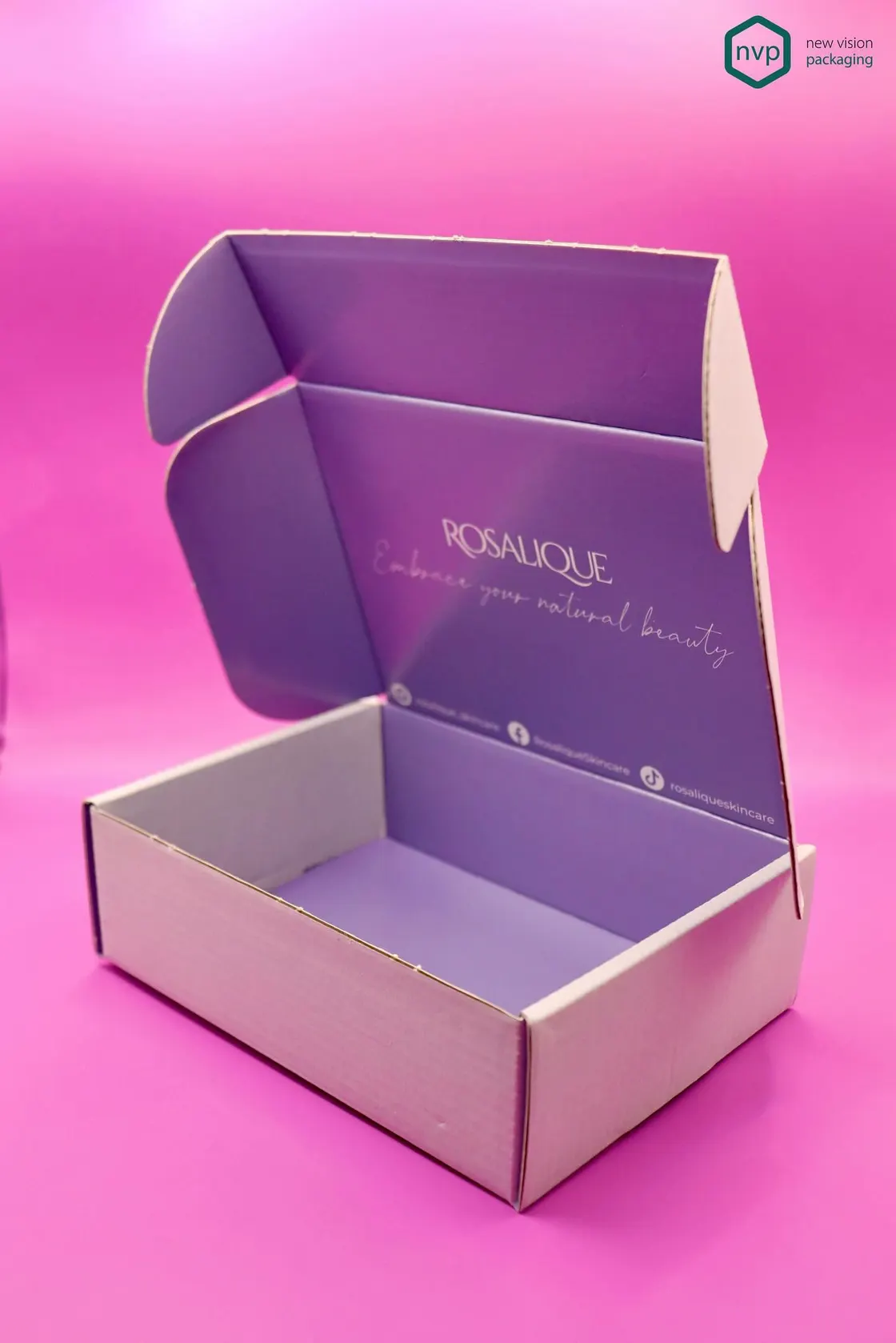 Pink and lilac Rosalique corrugated mailer opened to show the printed interior