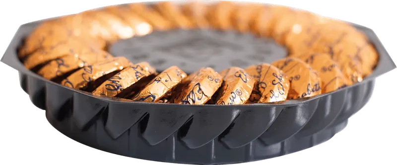 Black vacuum formed ring tray presenting branded biscuits around a central well