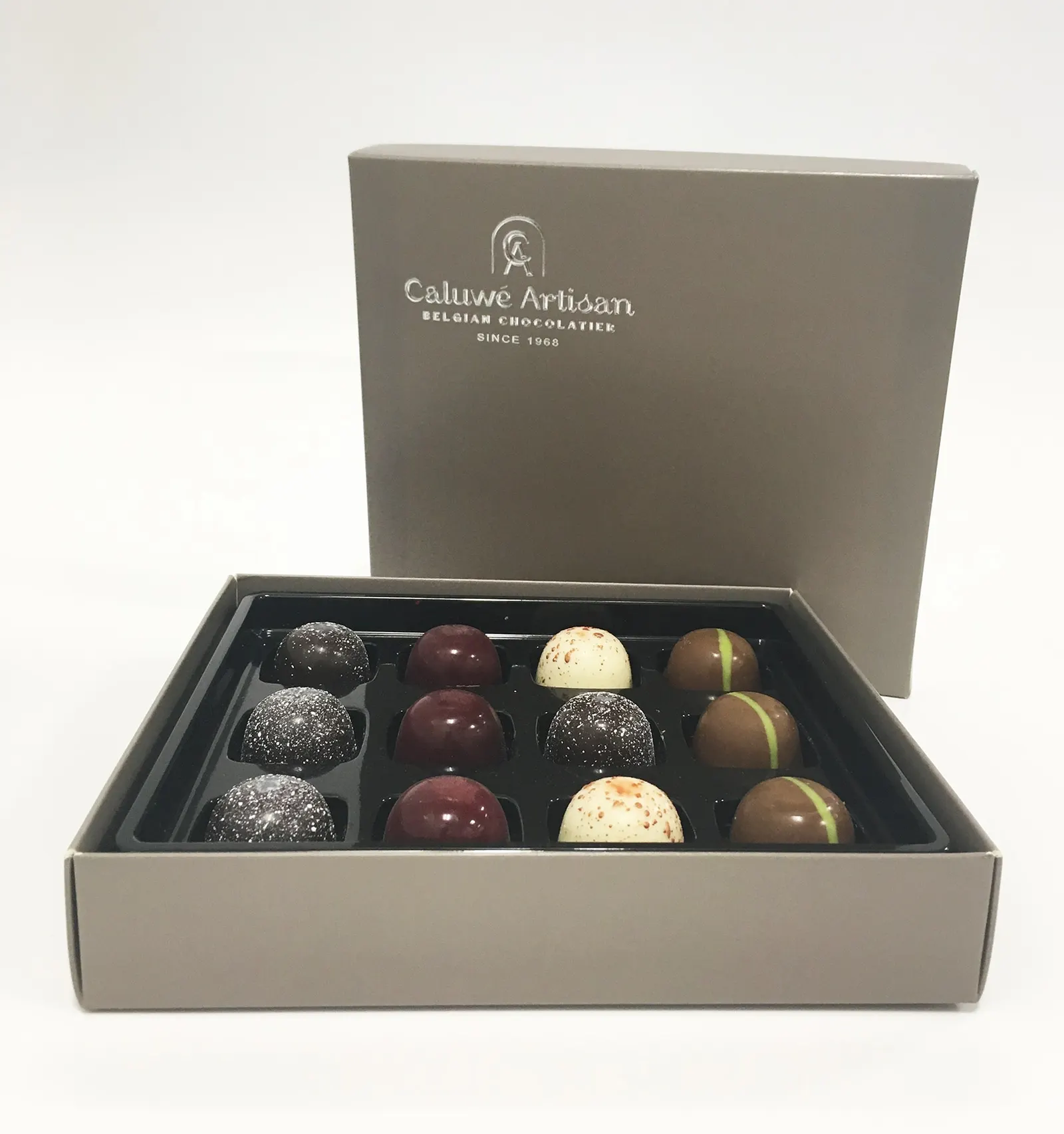 Caluwé Artisan chocolate box with a black vacuum formed tray holding twelve decorated chocolates